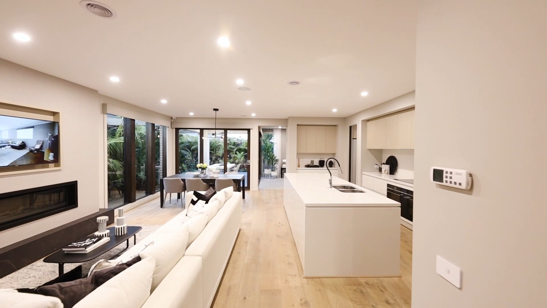 Open-plan living room and kitchen, a still from a cinematic walkthrough film